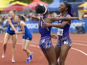 Lake Stevens’ Haddyjatou Ceesay, left, embraces Brianna Tilgham after coming in second in the 4A girls 400 relay final on Saturday, May 31, 2025 in Tacoma, Washington. (Olivia Vanni / The Herald)