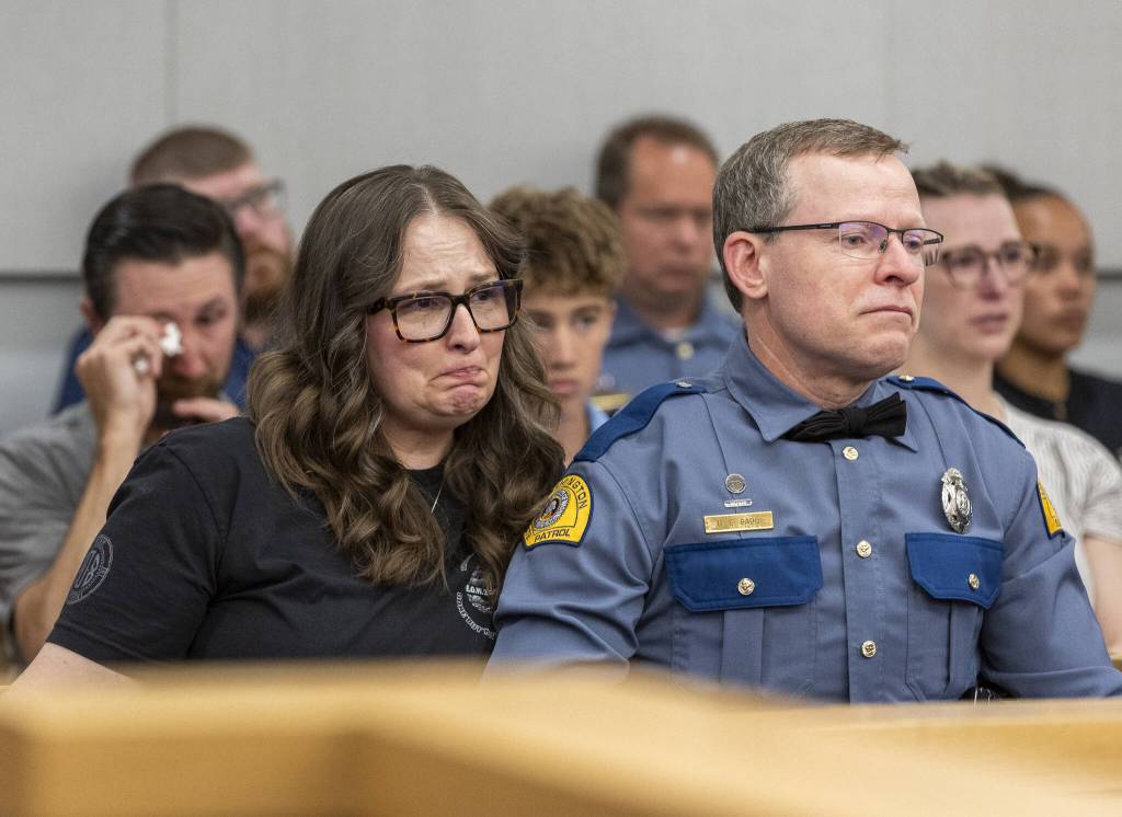 Washington State Patrol Trooper Christopher Gadds parents Gillian Gadd and WSP Trooper David Gadd listen as the judge delivers her sentence for Raul Benitez Santana during his hearing at the Snohomish County Courthouse on Wednesday, July 2, 2025 in Everett, Washington. (Olivia Vanni / The Herald)