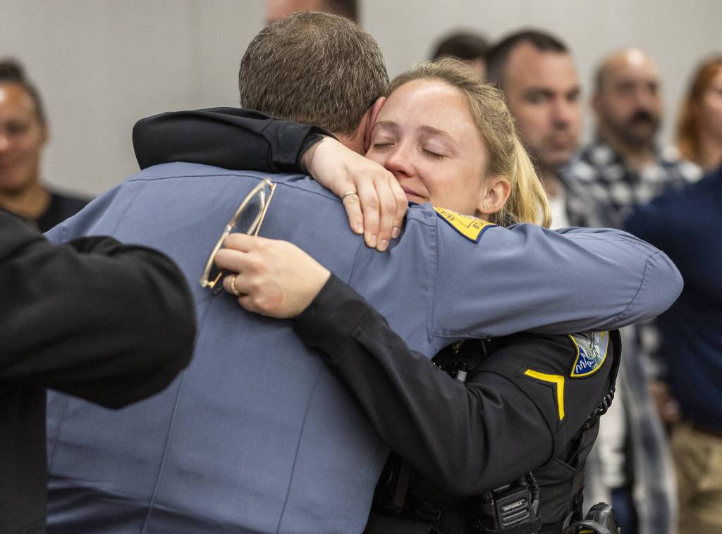Rebecca Bonnell hugs David Gadd after Raul Benitez Santana is given the maximum sentence during his hearing at the Snohomish County Courthouse on Wednesday, July 2, 2025 in Everett, Washington. (Olivia Vanni / The Herald)