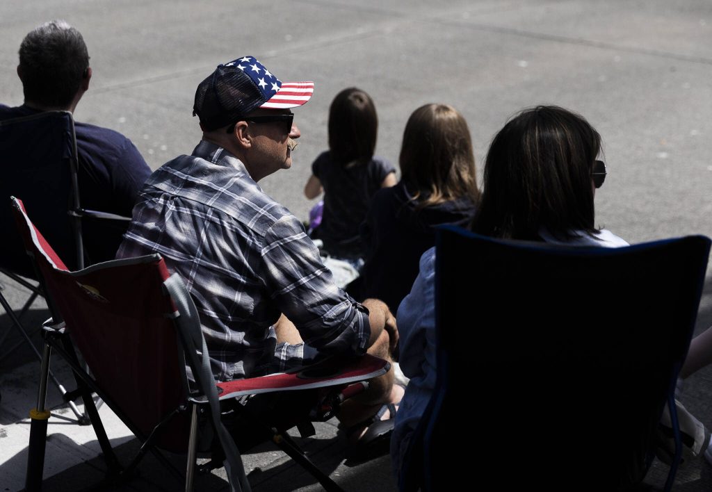 A man wears an American flag hat and watches the Fourth of July Parade on Friday, July 4, 2025 in Everett, Washington. (Olivia Vanni / The Herald)