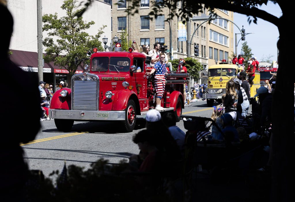 The Everett Fire Department drives multiple firetrucks down Colby Avenue during the Fourth of July parade Friday in Everett. (Olivia Vanni / The Herald)
