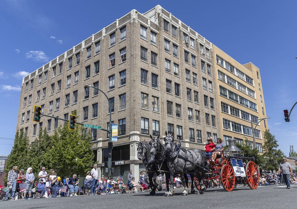 Everett Mayor Cassie Franklin rides in a carriage down Colby Avenue during the Fourth of July Parade on Friday, July 4, 2025 in Everett, Washington. (Olivia Vanni / The Herald)