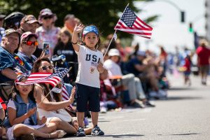 Liam Shakya, 3, waves at a float passing by during the Fourth of July Parade on Friday, July 4, 2025 in Everett, Washington. (Olivia Vanni / The Herald)
