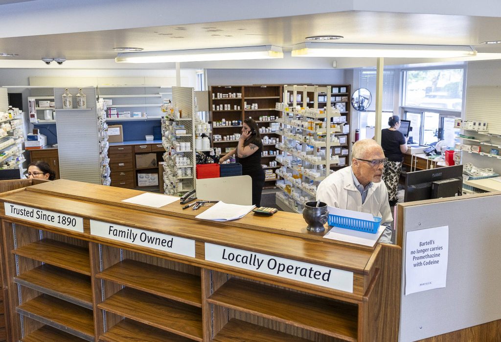 Pharmacist John Sontra and other employees work on calling customers to get their prescriptions transferred to other stores from the Bartell Drugs Pharmacy on Hoyt Avenue on Wednesday in Everett.