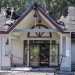 Red tape hangs in the front of the entrance to a burned down Center for Human Services building along 204th Street on Monday, July 7, 2025 in Lynnwood, Washington. (Olivia Vanni / The Herald)