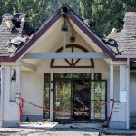 Red tape hangs in the front of the entrance to a burned down Center for Human Services building along 204th Street on Monday, July 7, 2025 in Lynnwood, Washington. (Olivia Vanni / The Herald)