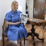 Annzolee Olsen sits on a chair from the 1958 movie Houseboat that her parents got at a Hollywood auction and holds a studio promo glossy of stars Cary Grant and Sophia Loren from The Daily Herald archives. The table is from a Robert Redford movie. (Olivia Vanni / The Herald)