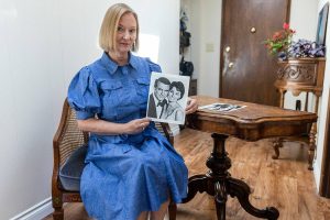 Annzolee Olsen with her chair, from Houseboat, and card table from a Robert Redford movie on Wednesday, July 23, 2025 in Everett, Washington. (Olivia Vanni / The Herald)