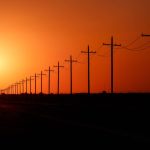 FILE — The sun sets over power lines in rural Ward County, Texas on Tuesday, May 20, 2025. Republicans plan to terminate billions of dollars in clean energy tax credits. Experts say that will mean more greenhouse gas emissions and more dangerous heat. (Paul Ratje/The New York Times)