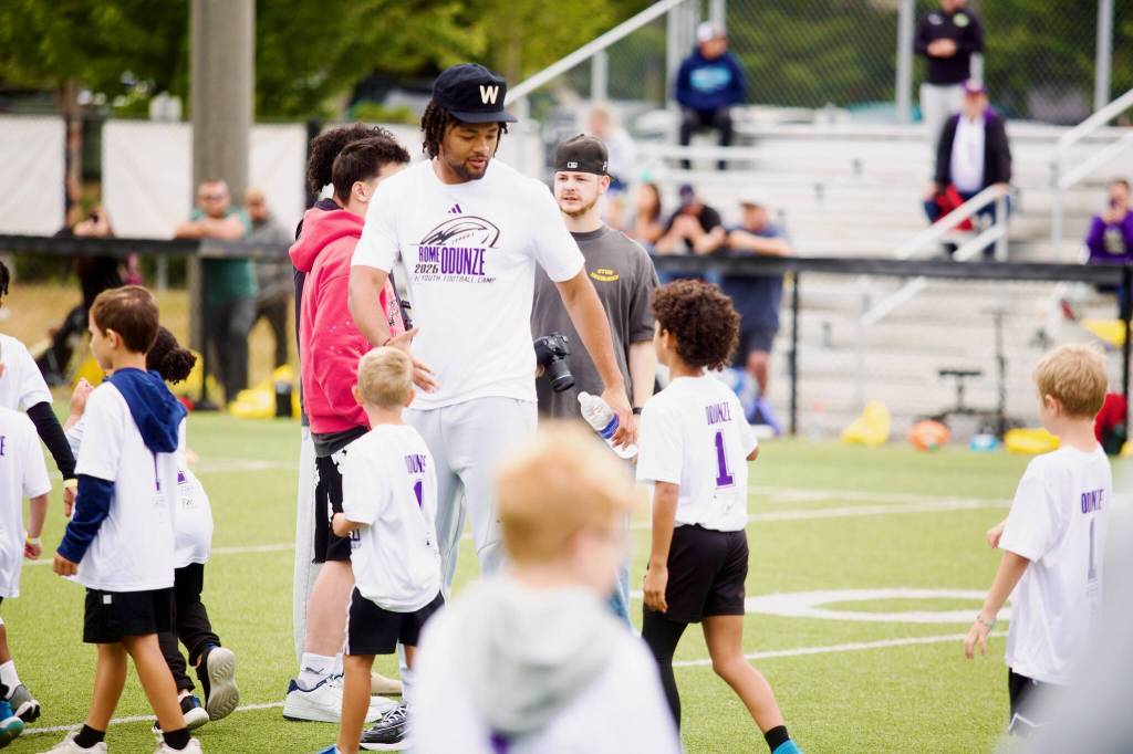 Rome Odunze interacts with campers during his youth football camp at Archbishop Murphy High School on July 10, 2025. (Joe Pohoryles / The Herald)