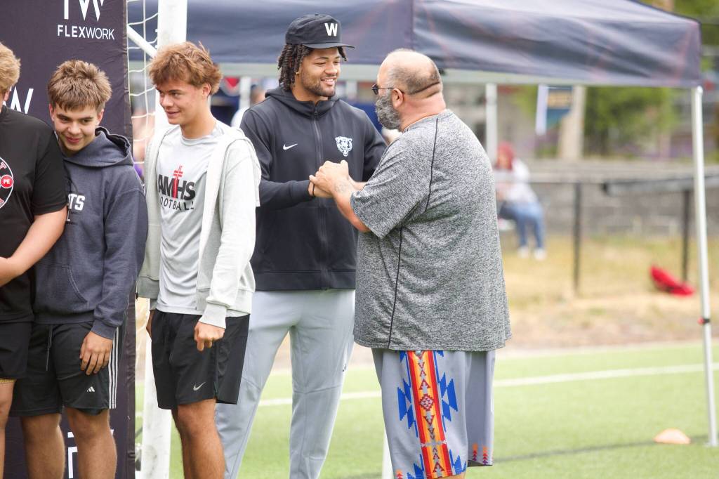 Rome Odunze greets the volunteers ahead of his youth football camp at Archbishop Murphy High School on July 10, 2025. (Joe Pohoryles / The Herald)