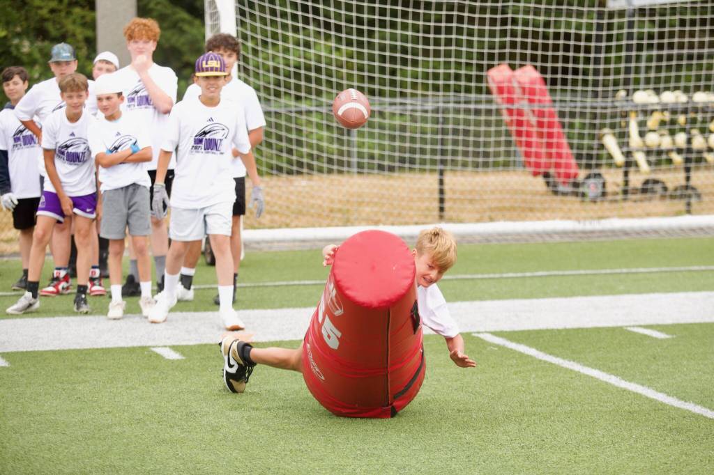 A camper at Rome Odunzes youth football camp engages in a fumble recovery drill at Archbishop Murphy High School on July 10, 2025. (Joe Pohoryles / The Herald)