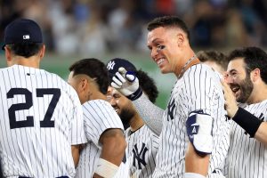 The New York Yankees' Aaron Judge, top right, celebrates with teammates after hitting a walk-off sacrifice fly ball during the 10th inning against the Seattle Mariners at Yankee Stadium on Thursday, July 10, 2025, in New York. (Justin Casterline / Getty Images / Tribune News Services)