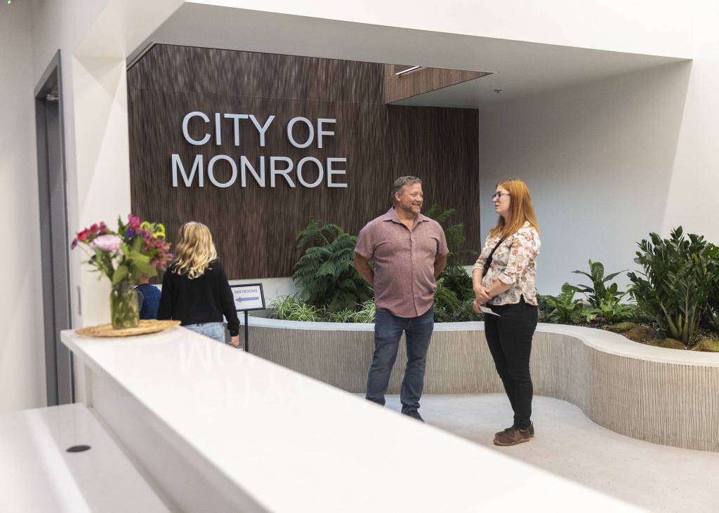 People gather in the lobby of the new City of Monroe building on Monday, July 14, 2025 in Monroe, Washington. (Olivia Vanni / The Herald)