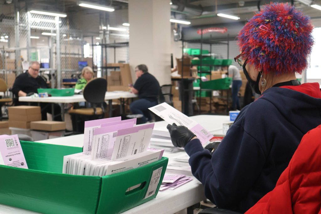 An elections worker sorts ballots at the elections center in downtown Everett. (Provided photo)
