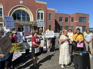 Jake Goldstein-Street / Washington State Standard
Angelina Godoy, director of the University of Washington Center for Human Rights, speaks to reporters alongside advocates outside Boeing Field in Seattle on Tuesday.