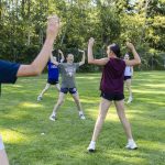 Anya Miller, 13, helps run warm up exercises before practice on Wednesday, July 16, 2025 in Mill Creek, Washington. (Olivia Vanni / The Herald)