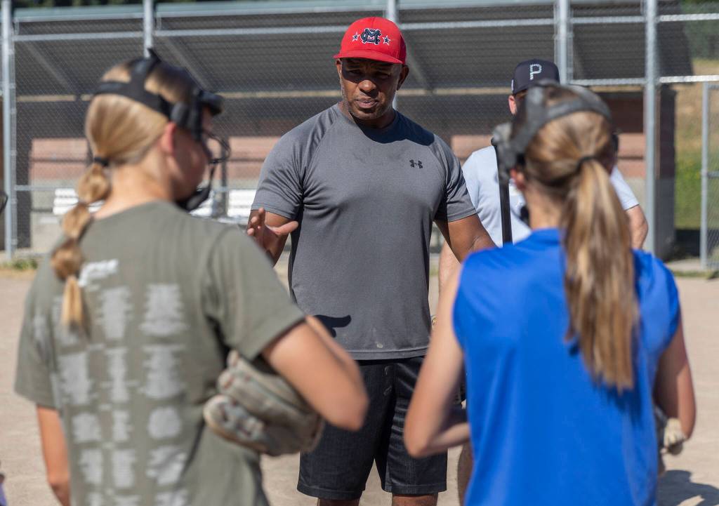 Mill Creek Little League softball Coach Courtney Brown talks to his players during practice on Wednesday, July 16, 2025 in Mill Creek, Washington. (Olivia Vanni / The Herald)