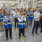 Richard Wong, center, the 777X wing engineering senior manager, cheers as the first hole is drilled in the 777-8 Freighter wing spar on Monday, July 21, 2025 in Everett, Washington. (Olivia Vanni / The Herald)