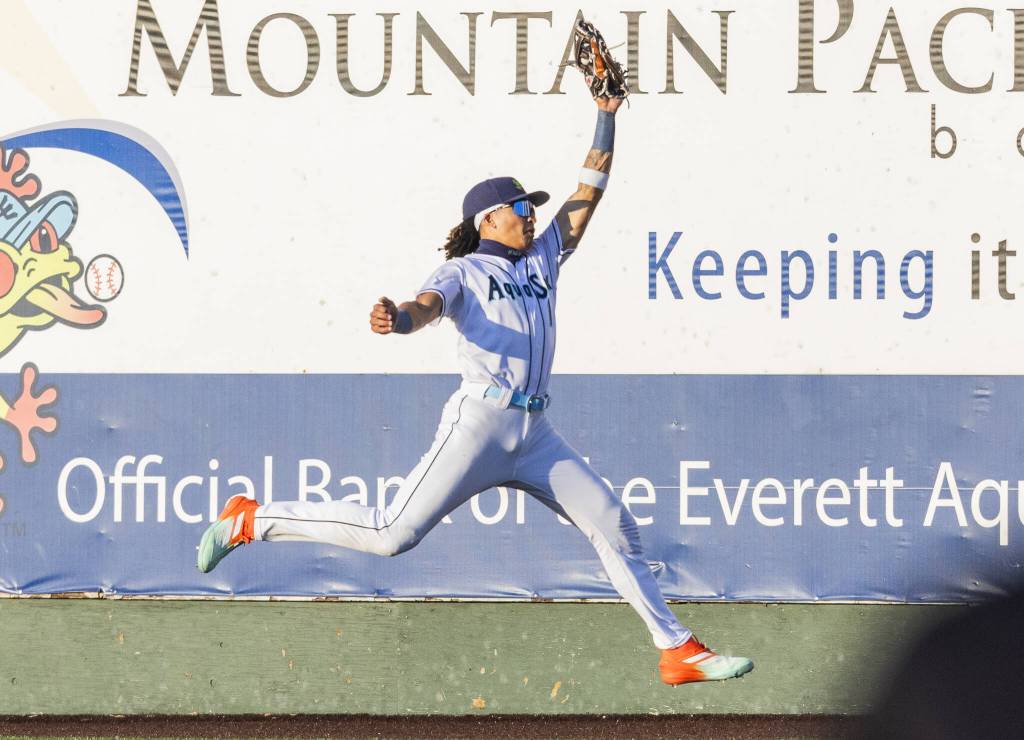 Everett AquaSox outfielder Tai Peete leaps in the air to make a catch during the game against the Spokane Indians on Tuesday, July 22, 2025 in Everett, Washington. (Olivia Vanni / The Herald)