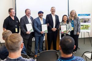 Doug McCormick (left to right), Dave Somers, Oscar Fuentes, Josh Brown, Clarissa Barrett and Kellie Snyder pose with Vision 2050 awards on Monday, July 28, 2025 in Everett, Washington. (Olivia Vanni / The Herald)