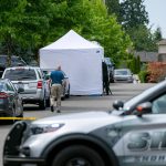 Police work on 96th Street SE where an overnight home invasion resulted in one person being killed on Friday, Aug. 19, 2022, in Everett, Washington. (Ryan Berry / The Herald)