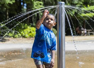 Elias Espinoza, 4, tries to catch a stream of water while playing in the spray park at Daleway Park in 72 degrees at noon on Monday, June 9, 2025 in Lynnwood, Washington. (Olivia Vanni / The Herald)