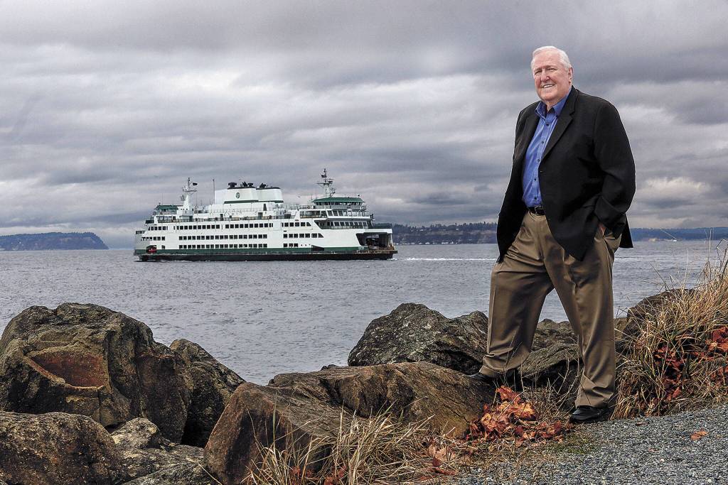 As a ferry heads across the water to Whidbey Island, Larry Hanson pauses along a path just outside the Losvar Condominiums, his home in Mukilteo. (Dan Bates / The Herald)