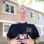 Jake Graham of Puyallup holds a photograph of his mother, Poppy, who died in Renton in 2010 when he was 17. Her ashes, recently discovered in the garage of a Lake Stevens rental home, are now with him. (Olivia Vanni / The Herald)
Jake Graham holds a photograph of his mother Poppy Graham on Monday, Aug. 11, 2025 in Everett, Washington. (Olivia Vanni / The Herald)