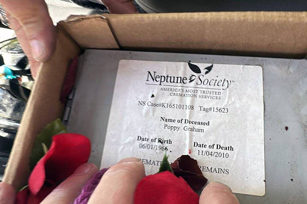 provided photo
Jake Graham holds a box containing the ashes of his late mother, Poppy.