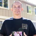 Jake Graham holds a photograph of his mother Poppy Graham on Monday, Aug. 11, 2025 in Everett, Washington. (Olivia Vanni / The Herald)