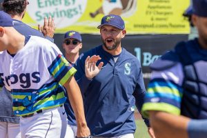 AquaSox pitching coach Matt Carasiti high-fives players before the start of a game on Thursday, July 24, 2025 in Everett, Washington. (Olivia Vanni / The Herald)