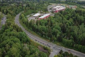 Cars drive along Cathcart Way next to the site of the proposed Eastview Village development that borders Little Cedars Elementary on Wednesday, May 7, 2025 in unincorporated Snohomish, Washington. (Olivia Vanni / The Herald)