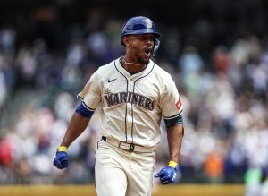 Julio Rodríguez (44) of the Seattle Mariners yells while running the bases after hitting his 100th career home run during the third inning against the Texas Ranger at T-Mobile Park on Sunday, Aug. 3, 2025, in Seattle. (Olivia Vanni / Getty Images / Tribune News Services)