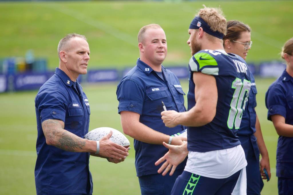 Seahawks receiver Cooper Kupp shakes hands with a couple military service members during the USAAs Salute to Service NFL Boot Camp hosted by the Seattle Seahawks at Virginia Mason Athletic Center on Aug. 4, 2025. (Joe Pohoryles / The Herald)