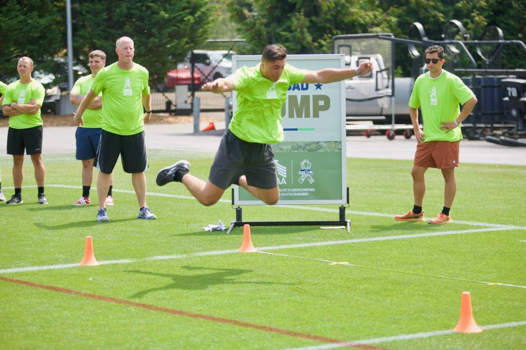 A military service member does the broad jump during the USAAs Salute to Service NFL Boot Camp hosted by the Seattle Seahawks at Virginia Mason Athletic Center on Aug. 4, 2025. (Joe Pohoryles / The Herald)