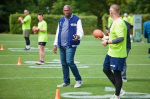 Seahawks legend Shaun Alexander chats with a participant during the USAA's Salute to Service NFL Boot Camp hosted by the Seattle Seahawks at Virginia Mason Athletic Center on Aug. 4, 2025. (Joe Pohoryles / The Herald)
