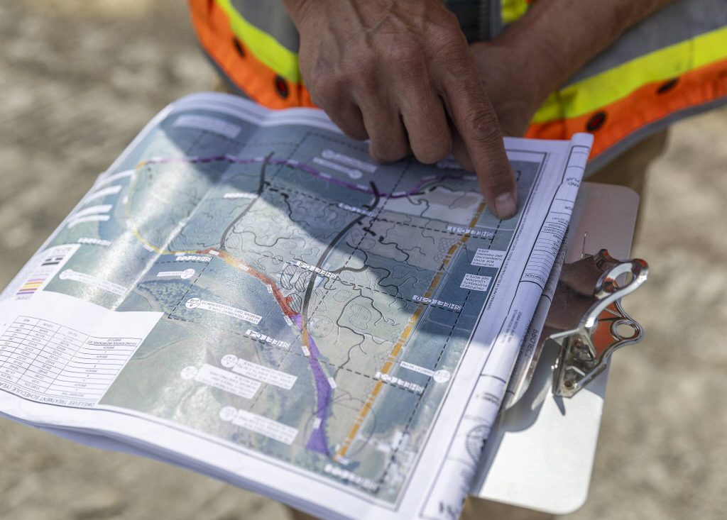 Jason Griffith talks about the dike changes and layout of the site on Monday, Aug. 4, 2025 in Stanwood, Washington. (Olivia Vanni / The Herald)