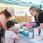 Participants browse a table at the Mariner Fest in Everett in 2024. (Provided photo)