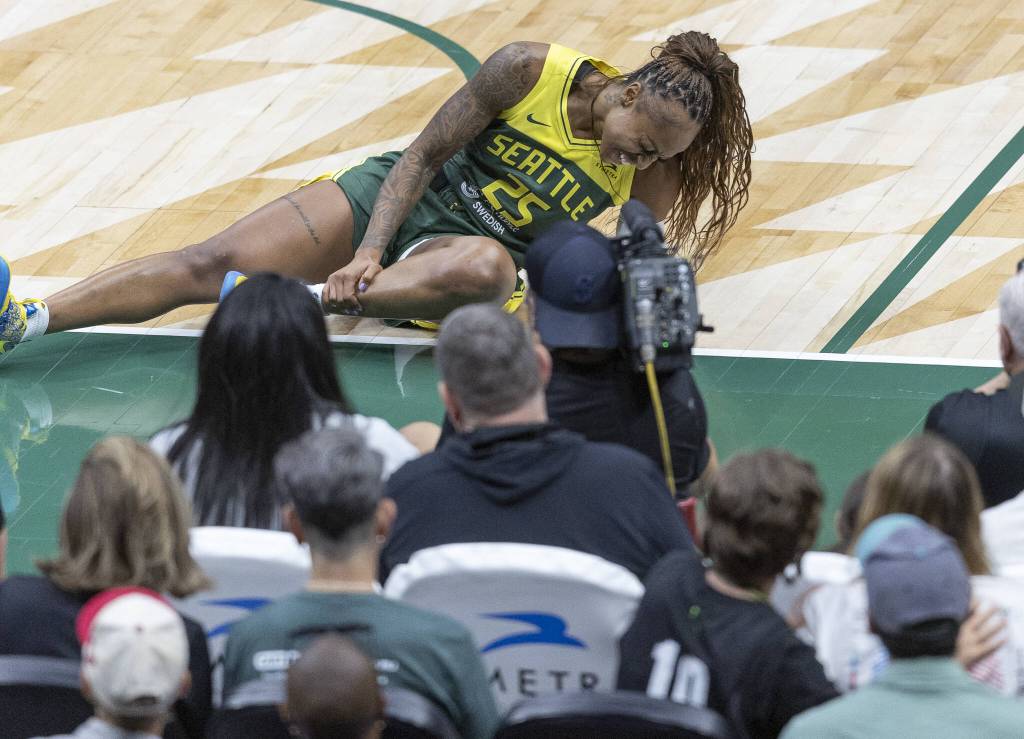 Seattle Storms Tiffany Mitchell grabs her lower leg after falling to the ground after a missed layup during the game against the Minnesota Lynx on Tuesday, Aug. 5, 2025 in Seattle, Washington. (Olivia Vanni / The Herald)