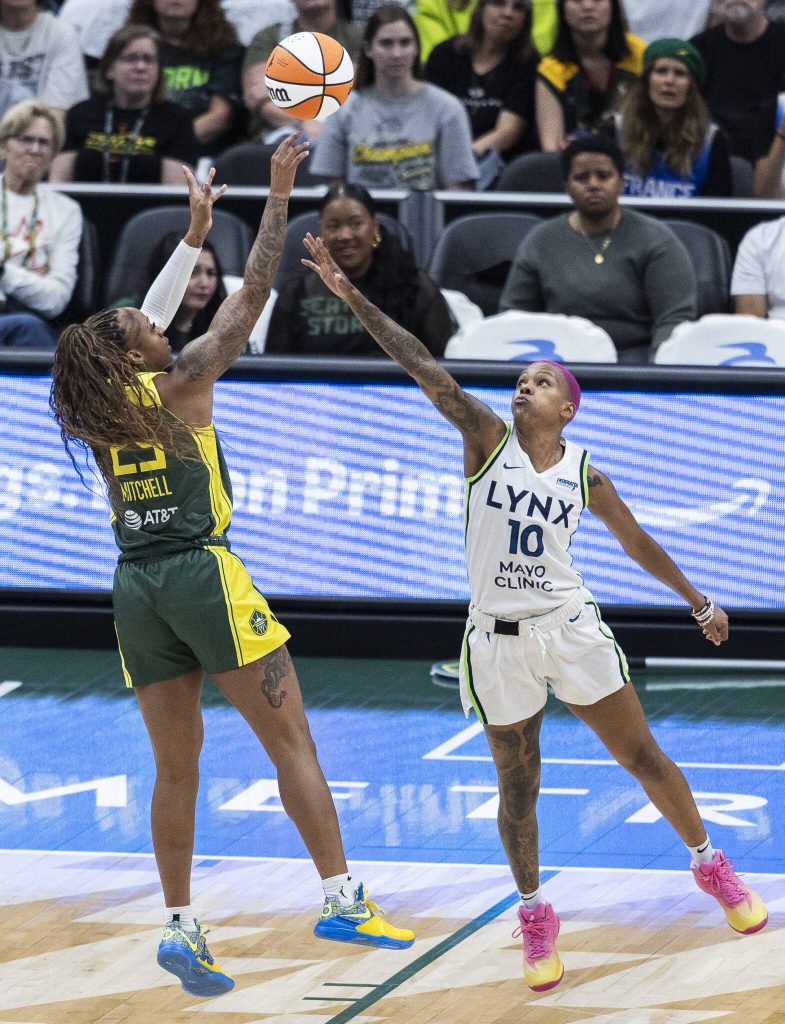 Seattle Storms Tiffany Mitchell takes a jump shot as Minnesota Lynxs Courtney Williams reaches to block it during the game on Tuesday, Aug. 5, 2025 in Seattle, Washington. (Olivia Vanni / The Herald)