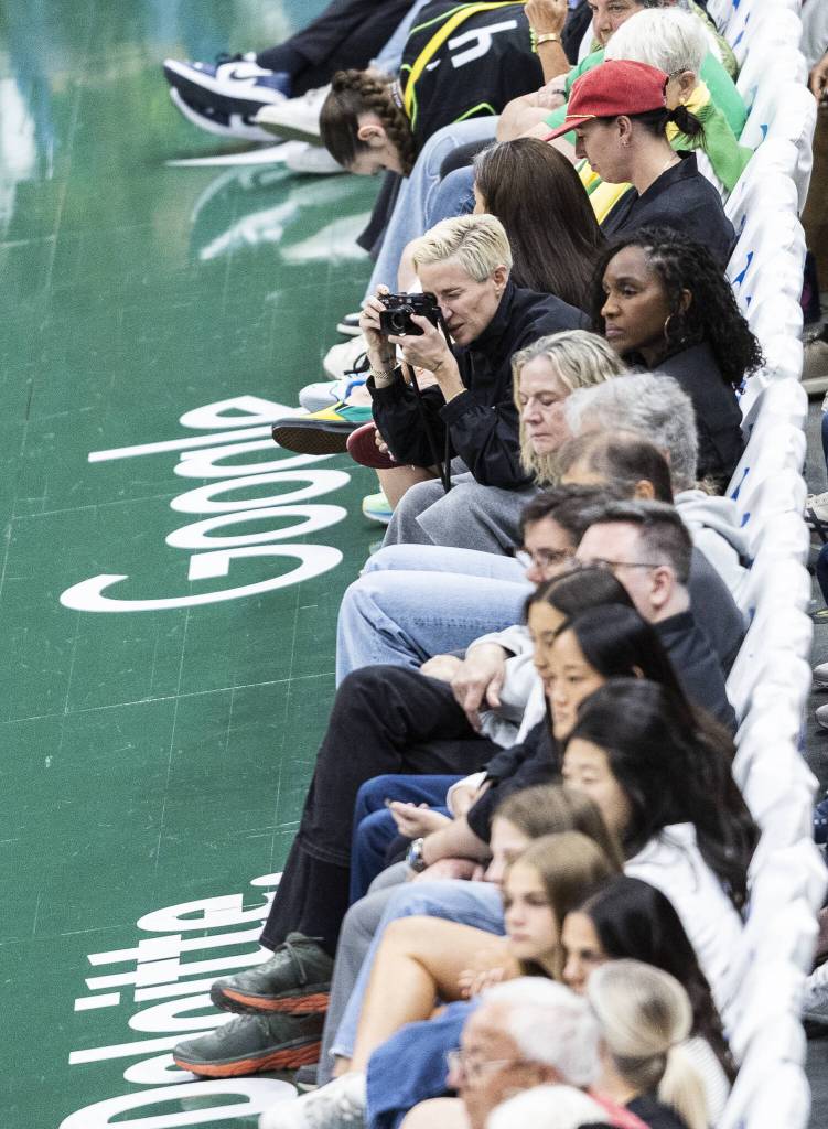 Seattle Reign and UWSNT star Megan Rapinoe takes photos courtside during the game on Tuesday, Aug. 5, 2025 in Seattle, Washington. (Olivia Vanni / The Herald)