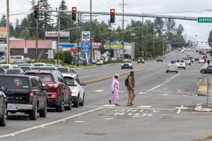 Pedestrians cross the intersection of Evergreen Way and Airport Road on Thursday, Aug. 7, 2025 in Everett, Washington. (Olivia Vanni / The Herald)