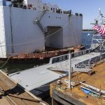 People look at the USX-1 Defiant, a first-of-its-kind autonomous naval ship, at Everett Ship Repair on Monday, Aug. 11, 2025 in Everett, Washington. (Olivia Vanni / The Herald)