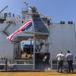 An American flag blows in the wind from the USX-1 Defiant, a first-of-its-kind autonomous naval ship, at Everett Ship Repair on Monday, Aug. 11, 2025 in Everett, Washington. (Olivia Vanni / The Herald)