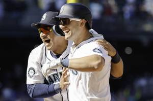 The Seattle Mariners' Dominic Canzone, right, celebrates with Donovan Solano after hitting a game-winning RBI single in the 11th inning against the Chicago White Sox at T-Mobile Park on Thursday, Aug. 7, 2025, in Seattle. (Alika Jenner / Getty Images / Tribune News Services)
