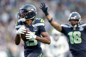Seahawks WR Tory Horton (15) runs with the ball as Elijah Arroyo (18) celebrates during a preseason game against the Las Vegas Raiders on Aug. 7, 2025 at Lumen Field in Seattle, Washington. (Steph Chambers / Getty Images)