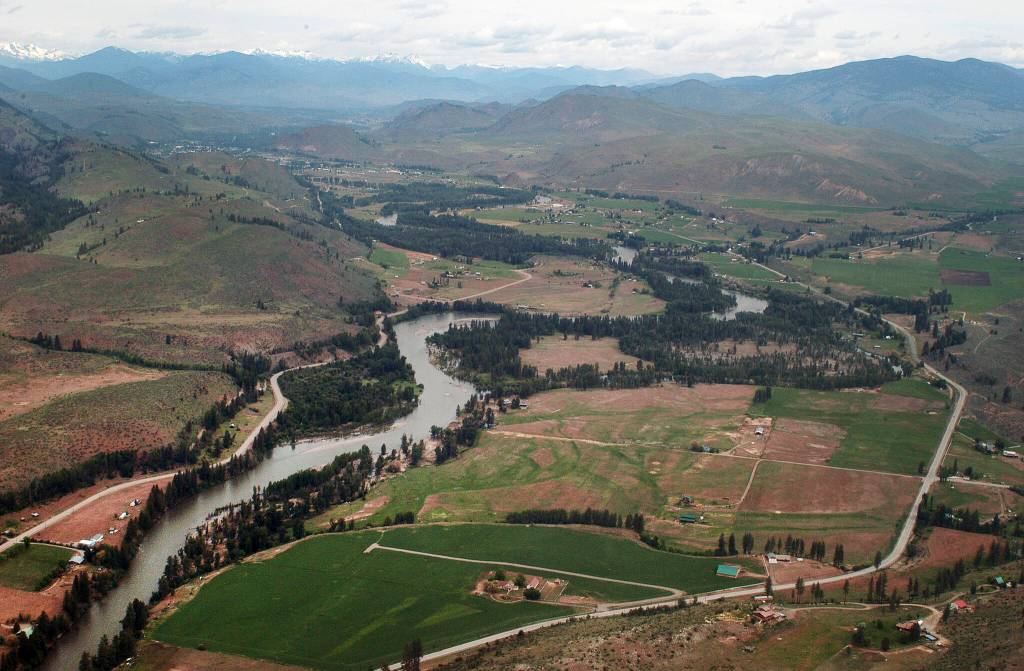 This 2007 aerial view of the Methow River is seen through the window of a small plane on a flight that originated from Twisp Municipal Airport. Looking north toward Twisp, about five miles up the road, the river is sandwiched between Highway 153 on the right and the Twisp-Carlton road on the left. (Sue Misao)