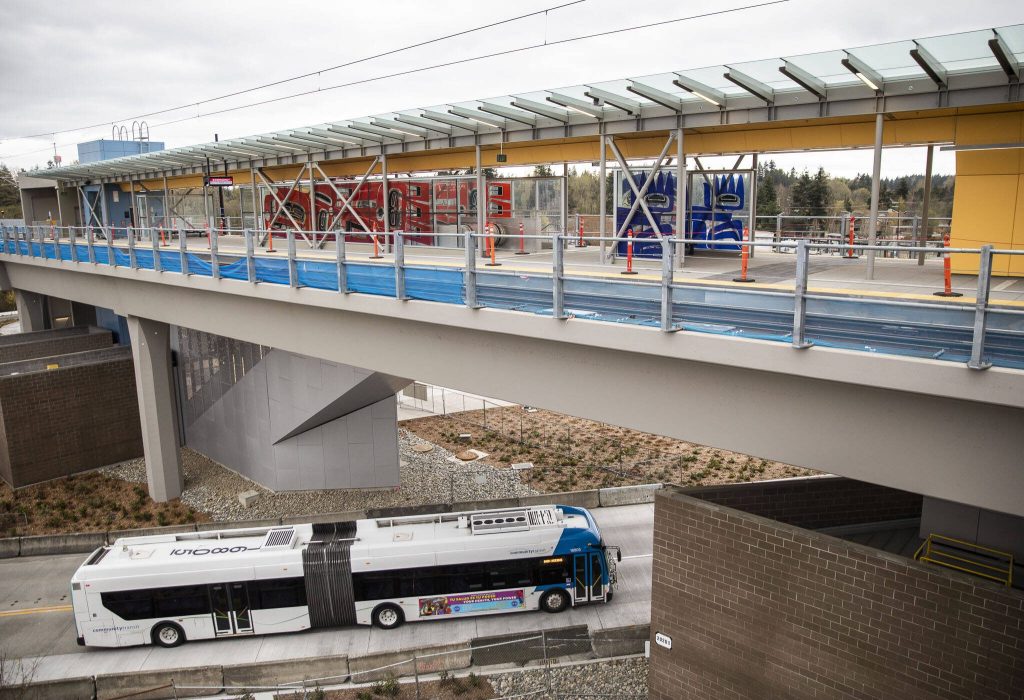 A Community Transit bus drives underneath the Lynnwood Light Rail station on Thursday, April 4, 2024 in Lynnwood, Washington. (Olivia Vanni / The Herald)