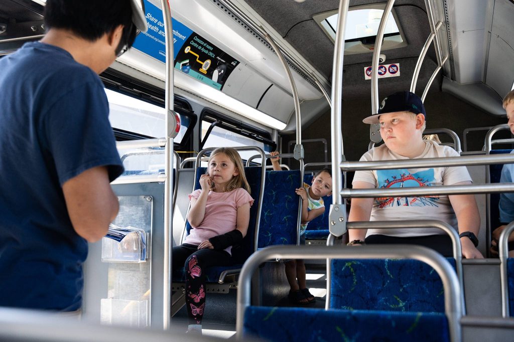 Children listen to a story at a Transit Tales event on Wednesday, Aug. 20, in Smokey Point, Washington. (Will Geschke / The Herald)